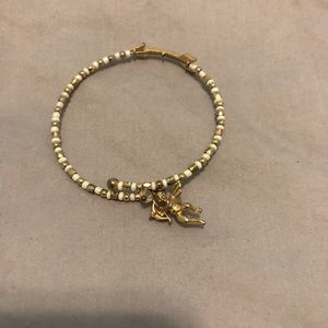 Cute white/gold bead bangle with Cupid and arrow!